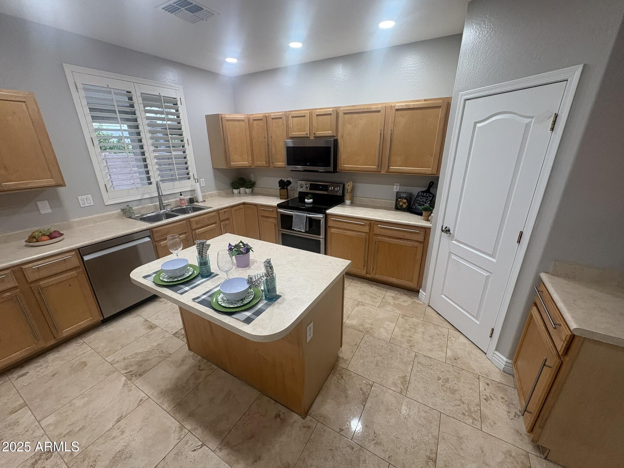 17633 North 41st Street Phoenix, AZ 85032 - Photo 5 of 24 a kitchen with stainless steel appliances granite countertop a sink a stove a microwave a refrigerator and a cabinets