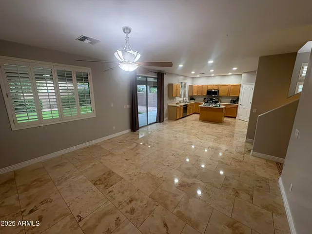 a view of a livingroom with a ceiling fan and window
