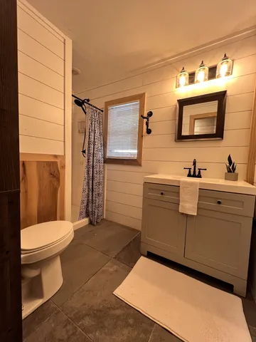 a bathroom with a toilet and a shower