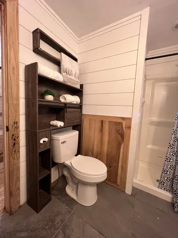 a bathroom with a toilet and shower