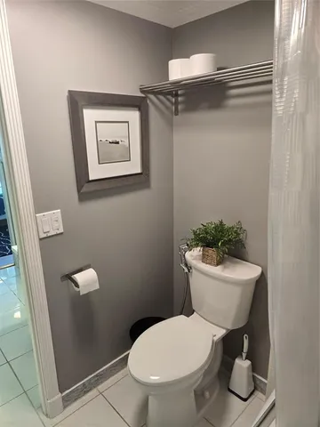 a bathroom with a toilet a sink and a shower