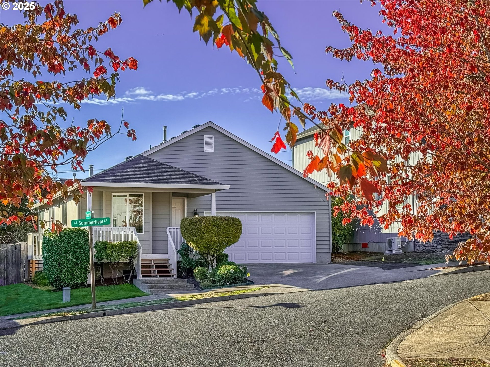 a view of a house with a yard and tree s