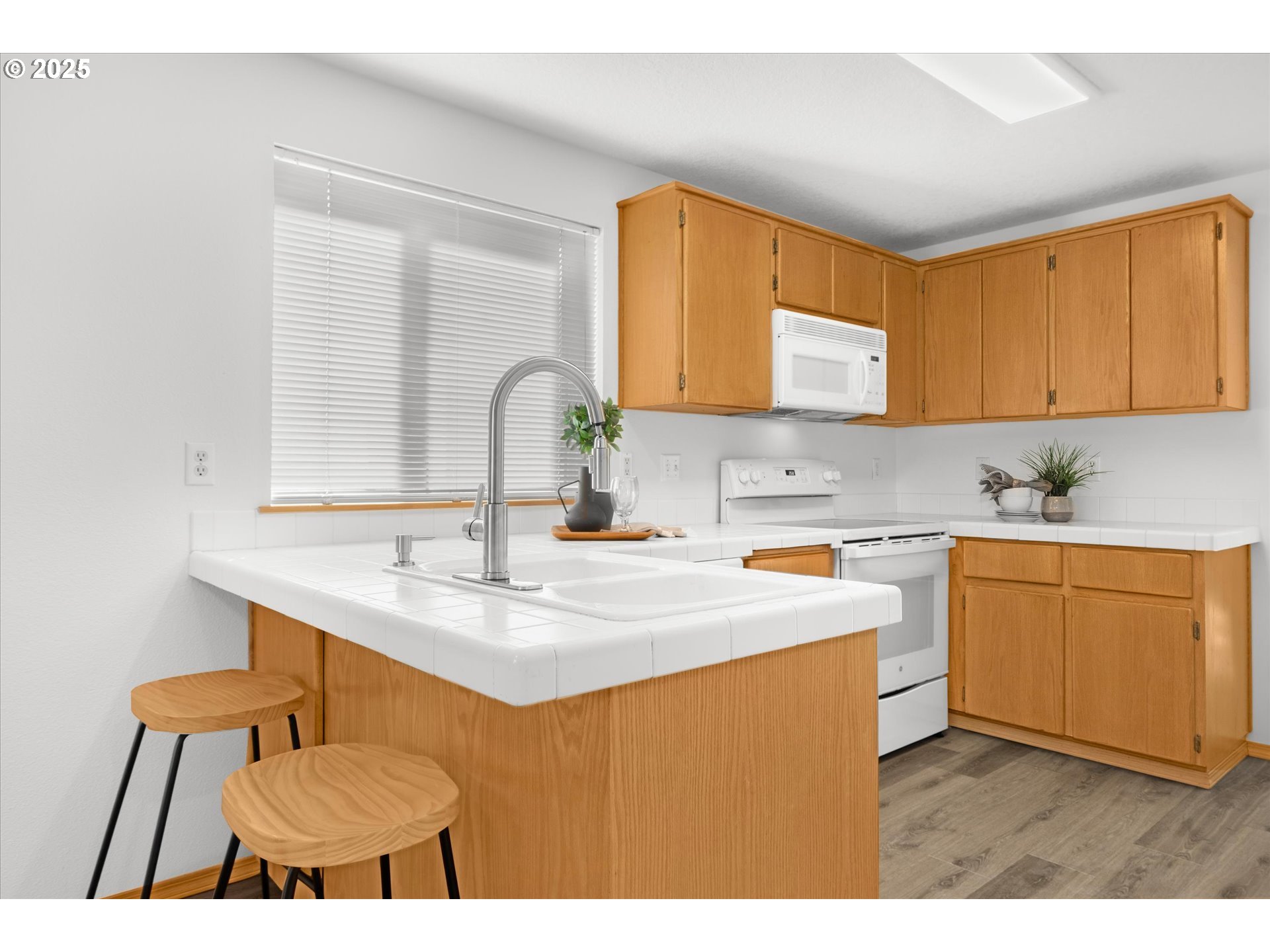 14029 Southeast Summerfield Loop Happy Valley, OR 97086 - Photo 11 of 47 a kitchen with stainless steel appliances kitchen island a sink table and chairs