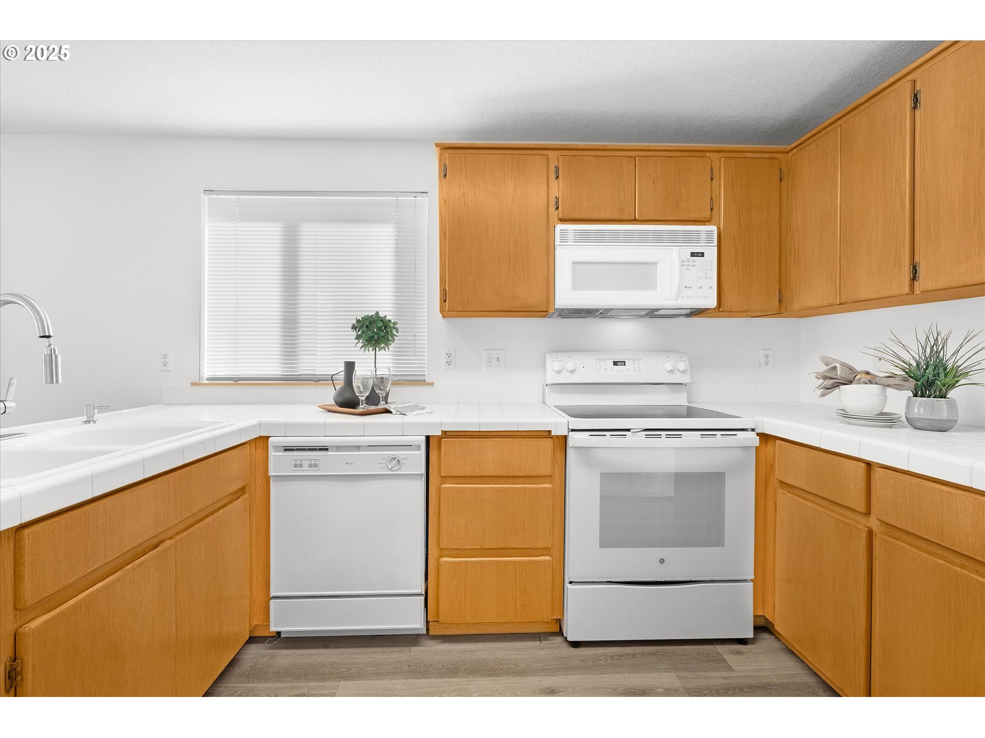 14029 Southeast Summerfield Loop Happy Valley, OR 97086 - Photo 13 of 47 a kitchen with a sink cabinets and window