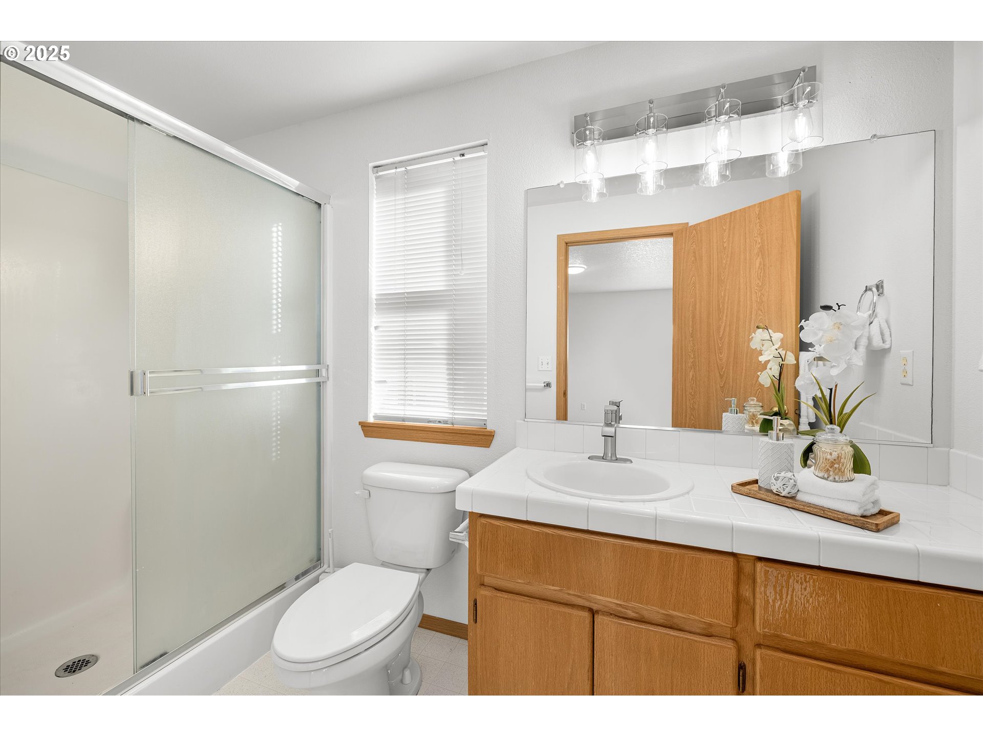 14029 Southeast Summerfield Loop Happy Valley, OR 97086 - Photo 23 of 47 a bathroom with a sink toilet a mirror and shower