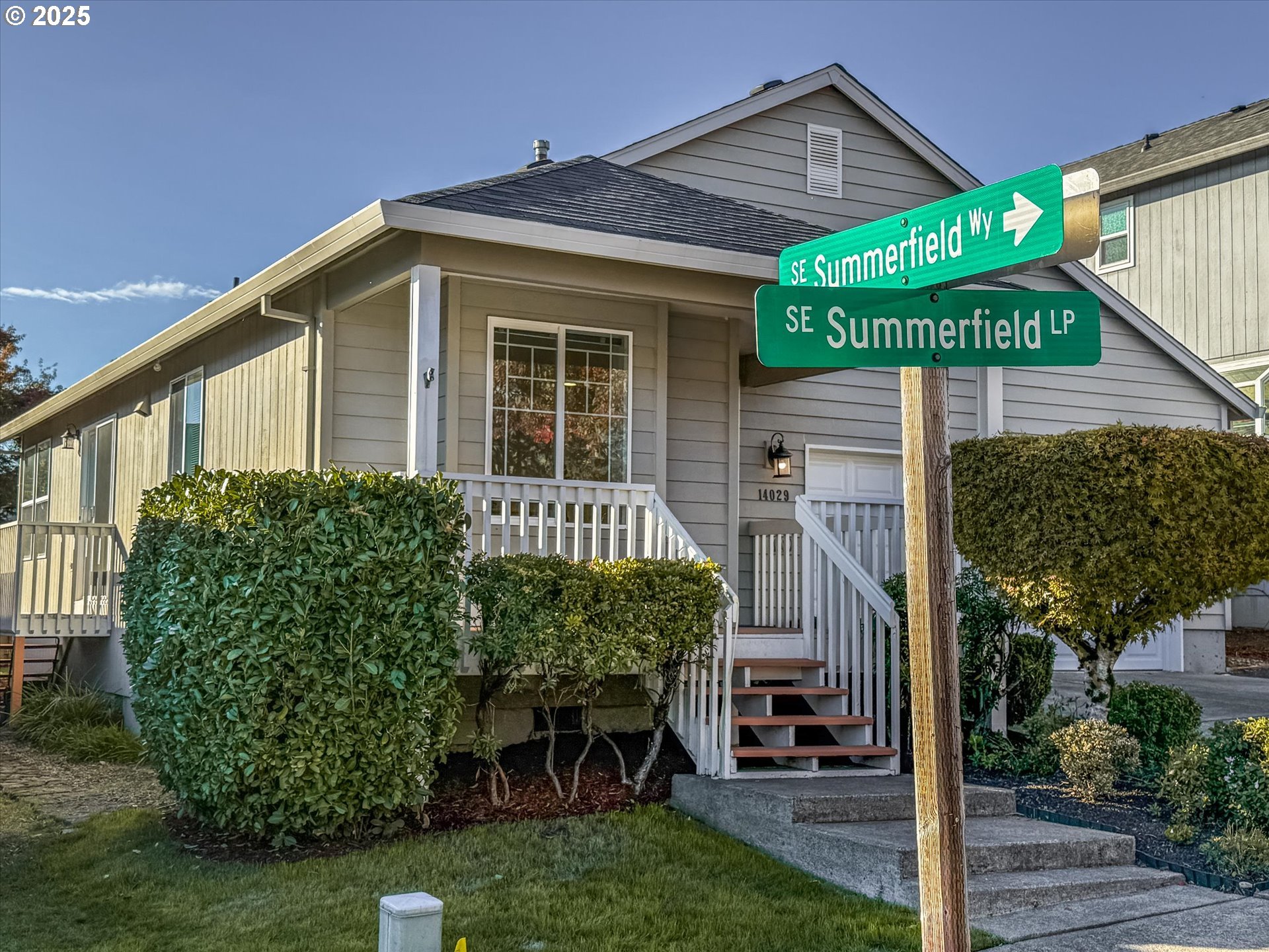 14029 Southeast Summerfield Loop Happy Valley, OR 97086 - Photo 4 of 47 a front view of a house with garden