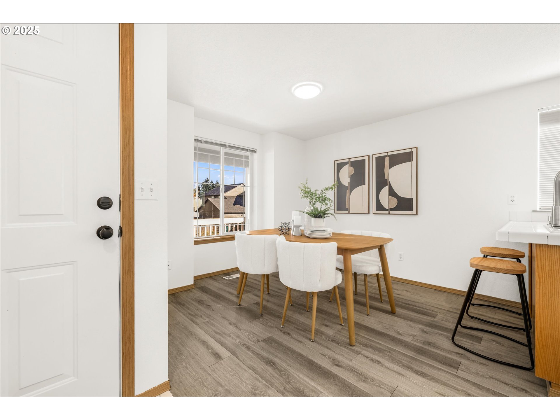 14029 Southeast Summerfield Loop Happy Valley, OR 97086 - Photo 10 of 47 a view of a dining room with furniture and wooden floor