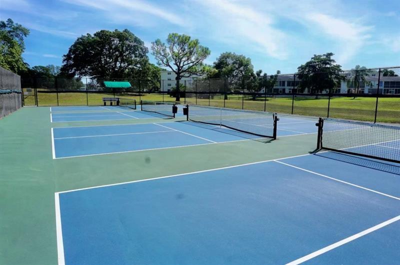 104 Westbury East, Unit 104 Deerfield Beach, FL 33442 - Photo 35 of 40 a view of a tennis court