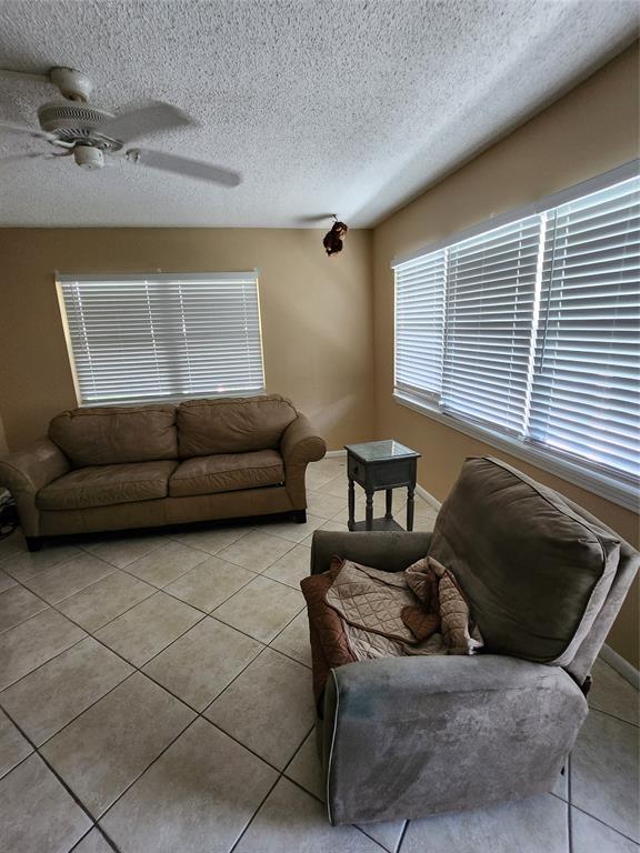 104 Westbury East, Unit 104 Deerfield Beach, FL 33442 - Photo 6 of 40 a living room with furniture and a window