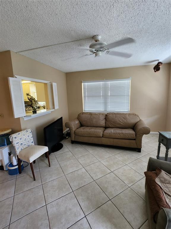 104 Westbury East, Unit 104 Deerfield Beach, FL 33442 - Photo 7 of 40 a living room with furniture and a window