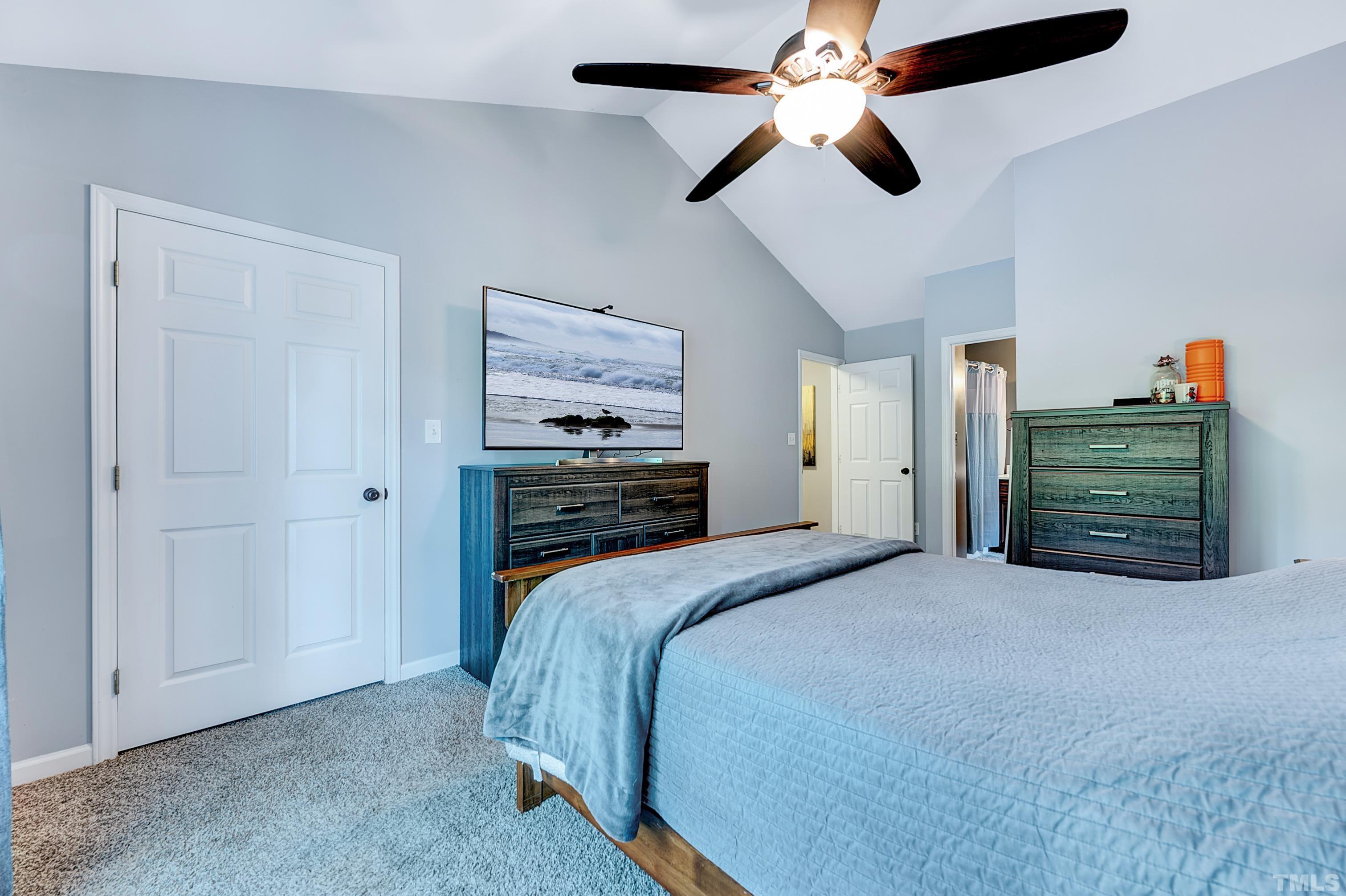 5109 Antler Ridge Court Raleigh, NC 27616 - Photo 24 of 30 a bedroom with a bed and a chandelier
