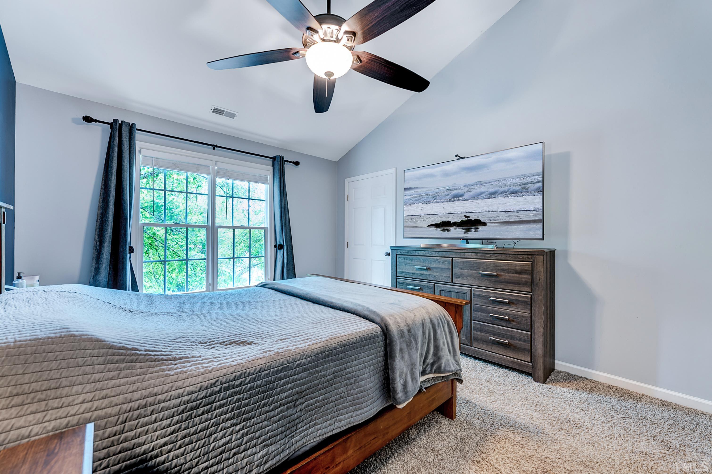 5109 Antler Ridge Court Raleigh, NC 27616 - Photo 25 of 30 a bedroom with a bed and a ceiling fan