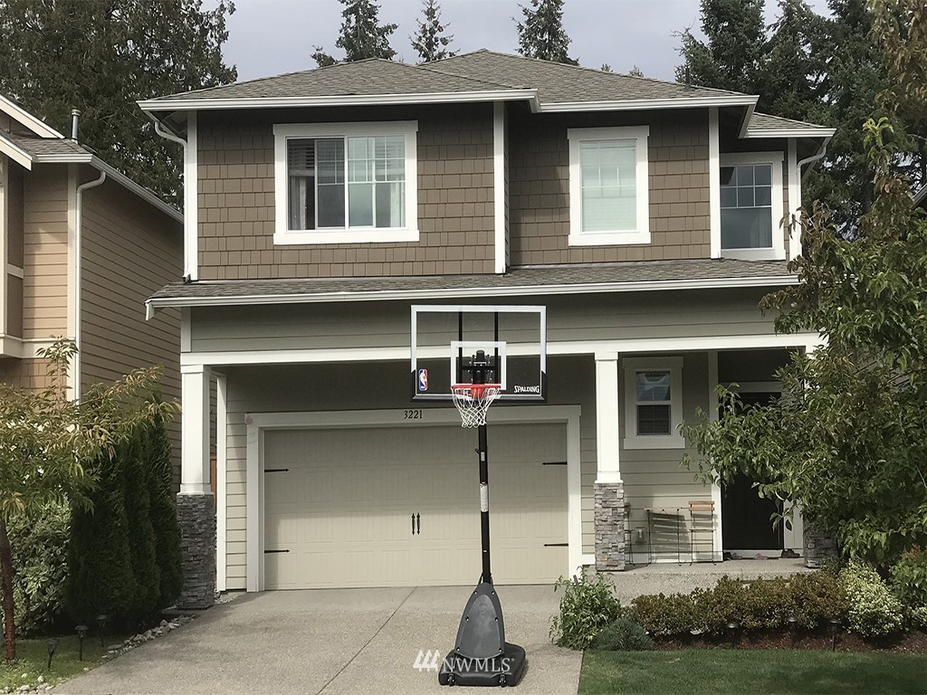 3221 170th Place Southeast Bothell, WA 98012 - Photo 1 of 1 a front view of a house with a yard garage and outdoor seating