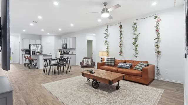 a living room with furniture and kitchen view
