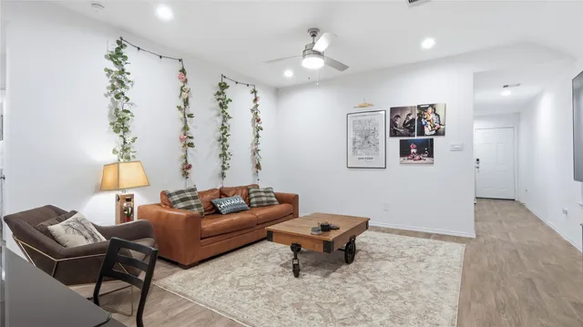 a living room with furniture and wooden floor