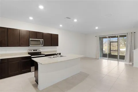 a kitchen with stainless steel appliances a stove a sink and a microwave