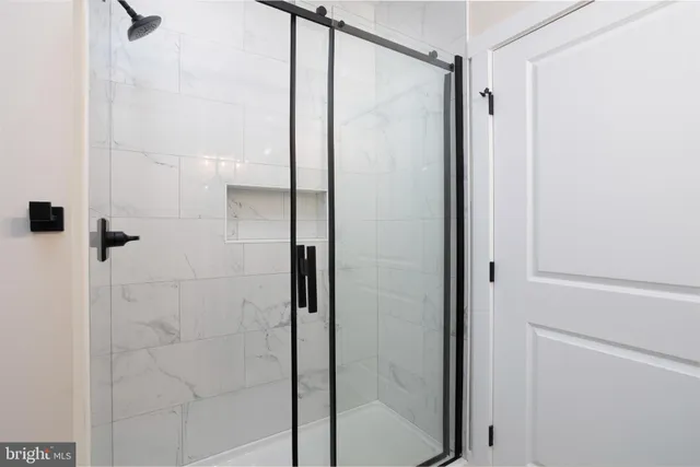 a bathroom with a glass shower door