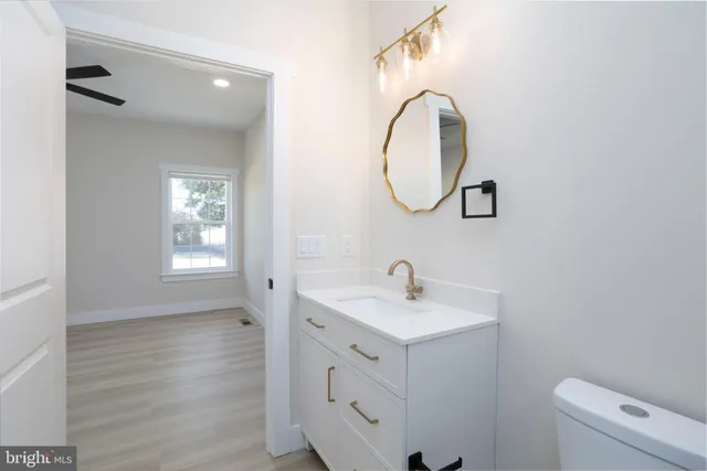 a bathroom with a toilet sink and mirror