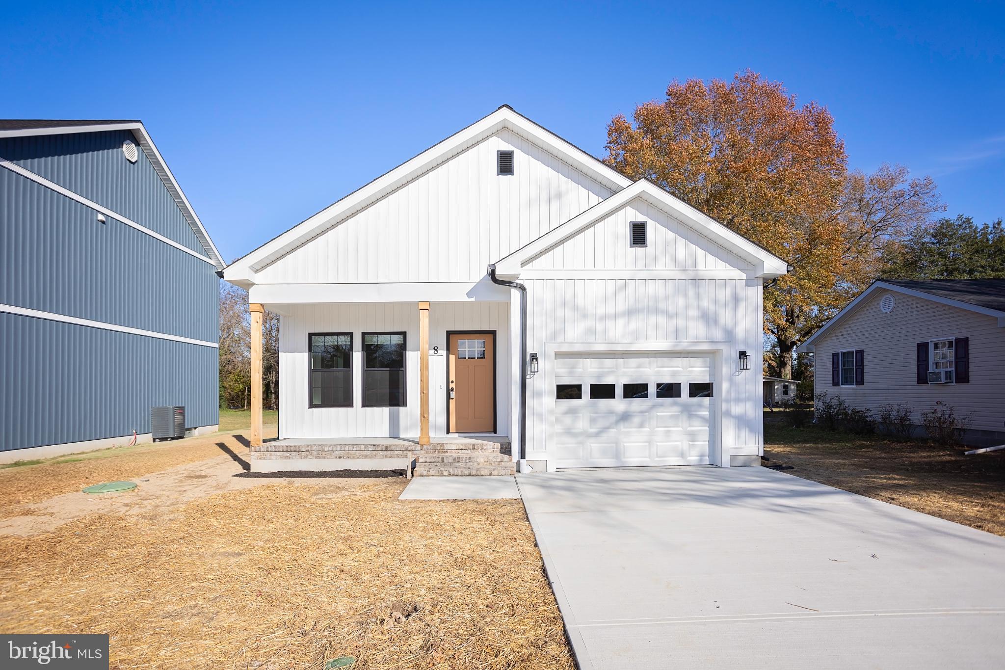 8 Sunrise Avenue Ridgely, MD 21660 - Photo 2 of 23 a front view of a house with a yard and garage