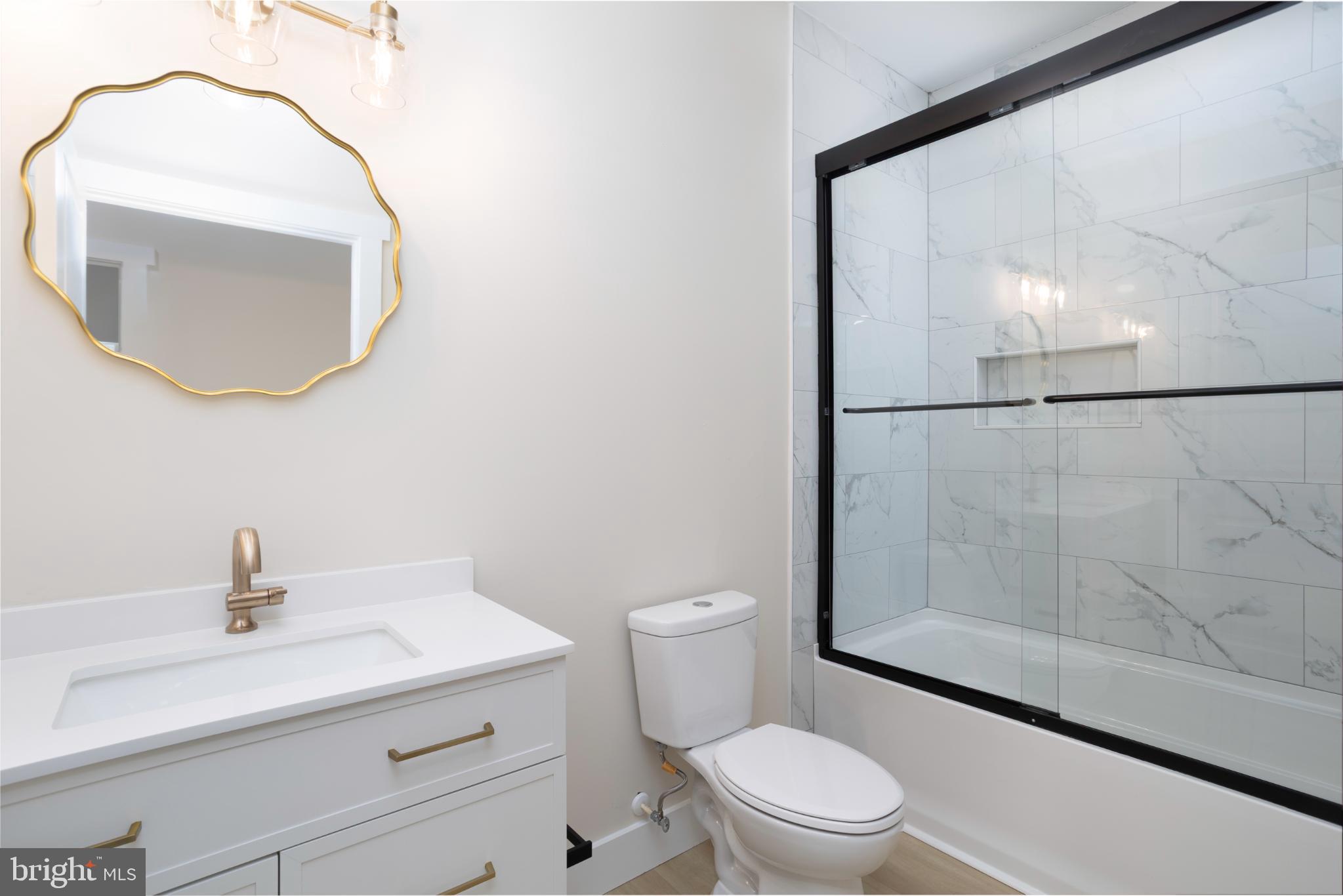 8 Sunrise Avenue Ridgely, MD 21660 - Photo 22 of 23 a bathroom with a sink a toilet and a mirror