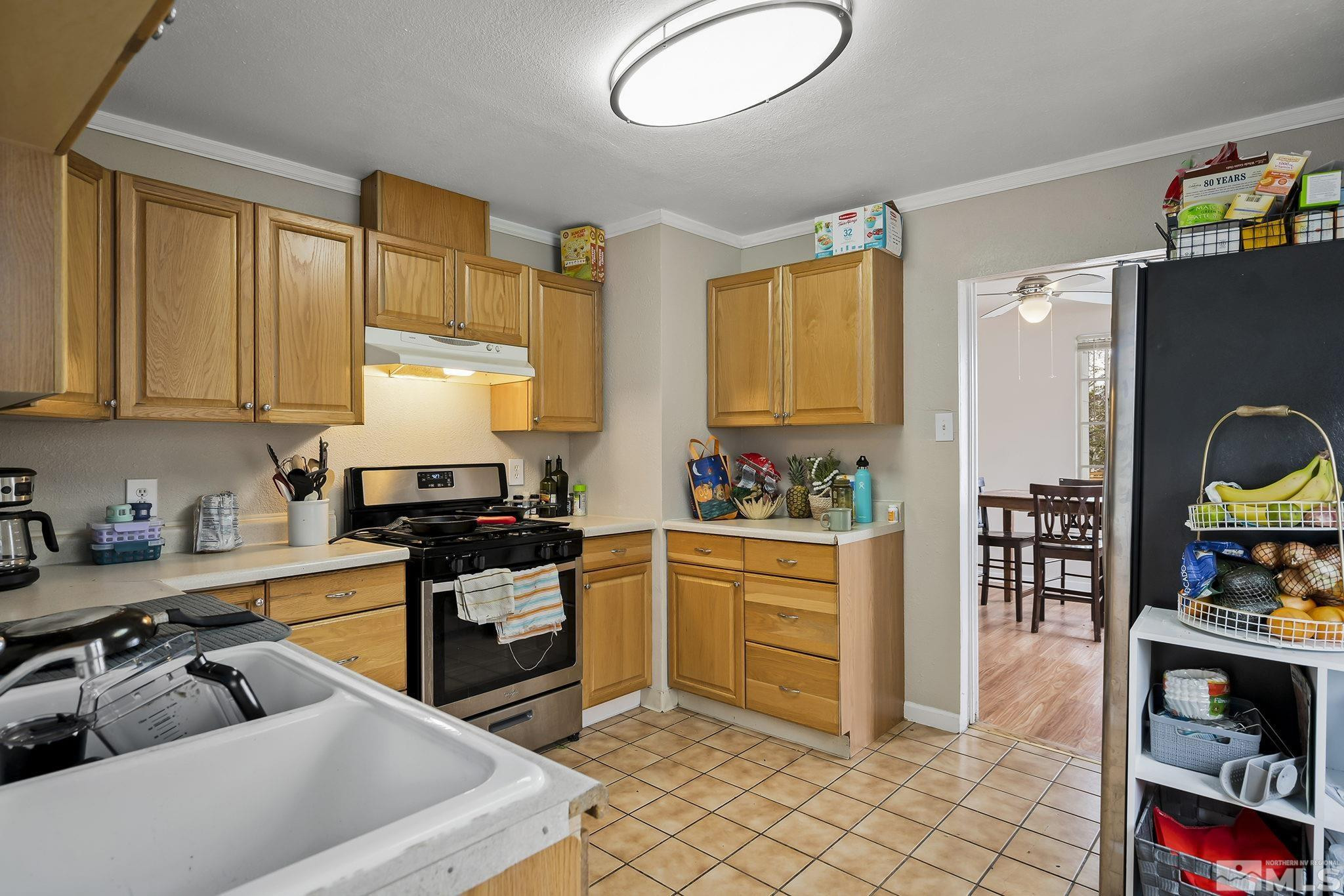 919-915 Bell Street Reno, NV 89503 - Photo 6 of 13 a kitchen with stainless steel appliances granite countertop a stove a sink and a refrigerator
