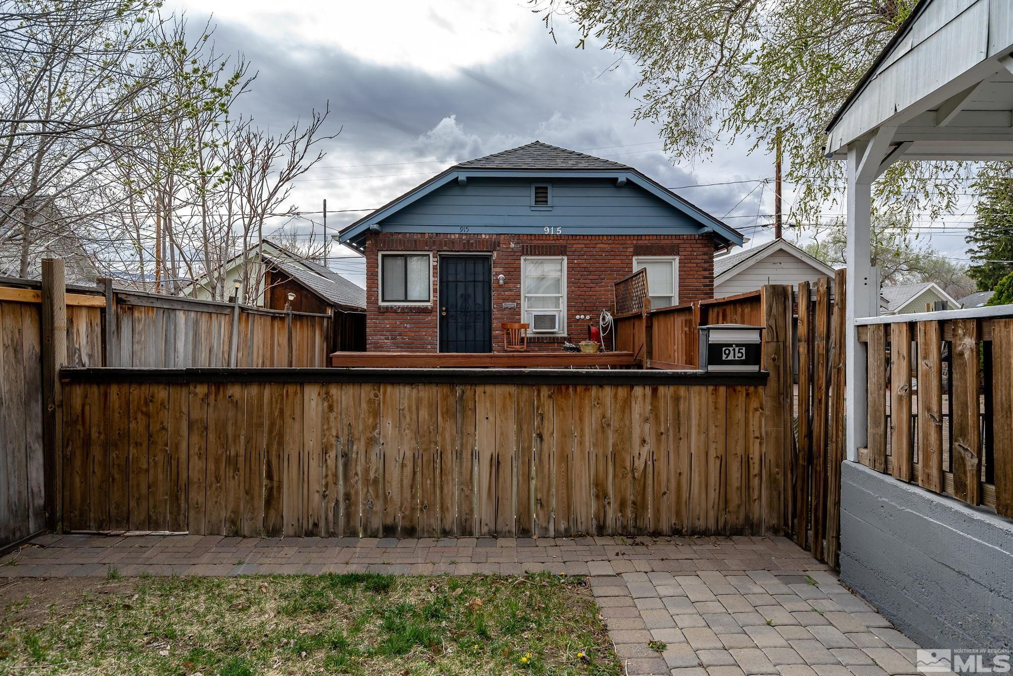 919-915 Bell Street Reno, NV 89503 - Photo 7 of 13 a view of a small house with wooden fence