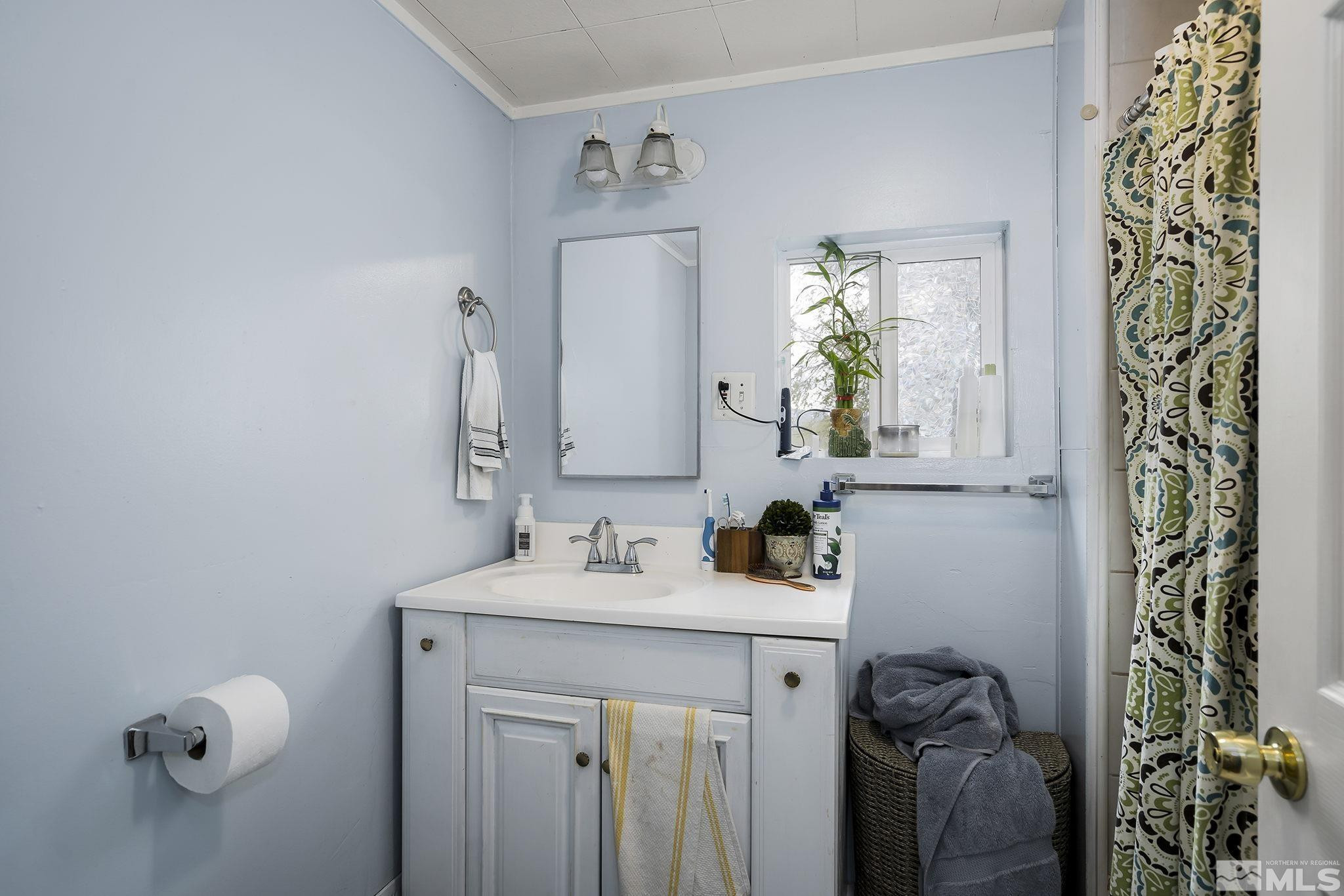 919-915 Bell Street Reno, NV 89503 - Photo 9 of 13 a bathroom with a sink and a mirror