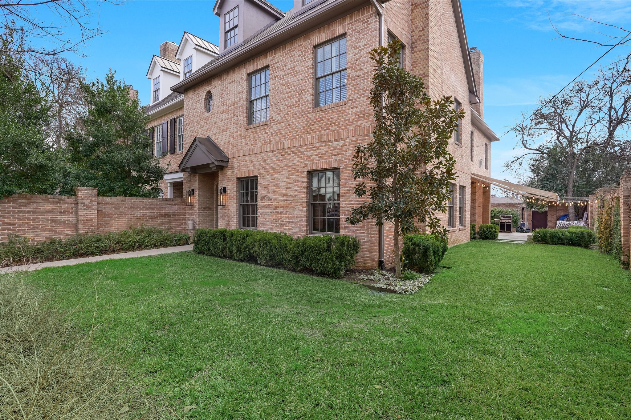 3705 Gilbert Street, Unit B Austin, TX 78703 - Photo 3 of 35 View of side of property with a yard, fence, and brick siding
