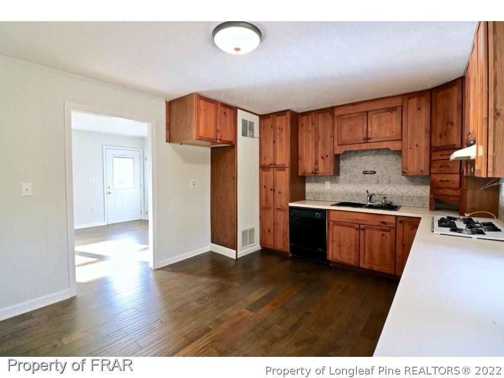 1548 Linden Road Aberdeen, NC 28315 - Photo 6 of 34 a kitchen with a refrigerator sink and cabinets