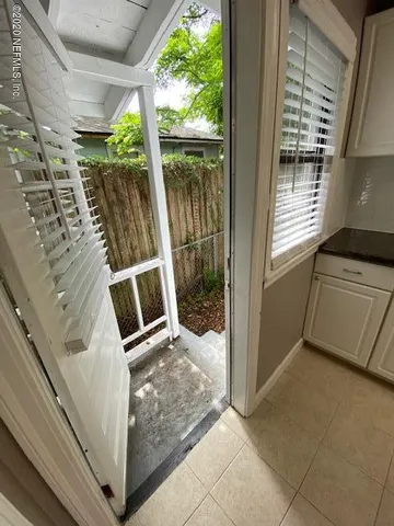 a view of a back yard from the balcony