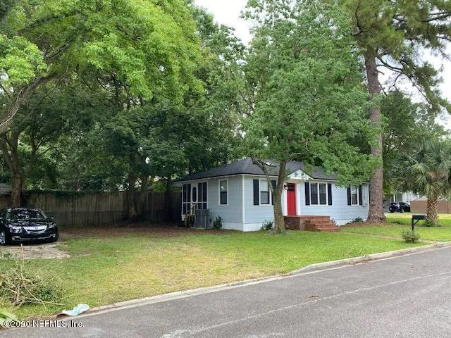 a view of a house with a yard and sitting area