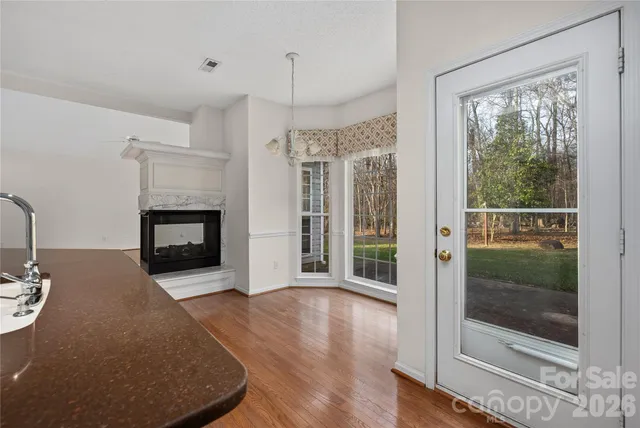 a view of a livingroom with a fireplace and window