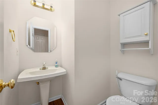 a bathroom with a sink mirror and toilet