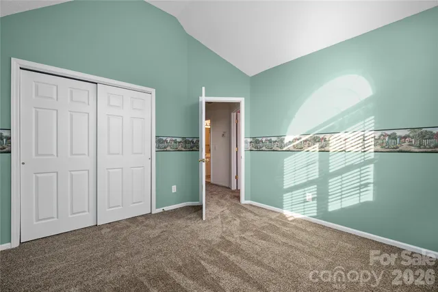 a view of a room with a fan and window