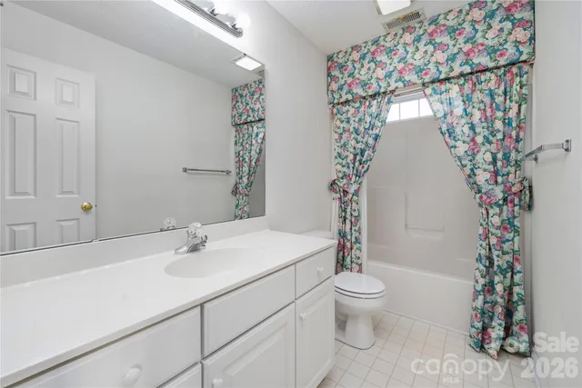 a view of a room with a fan and a window