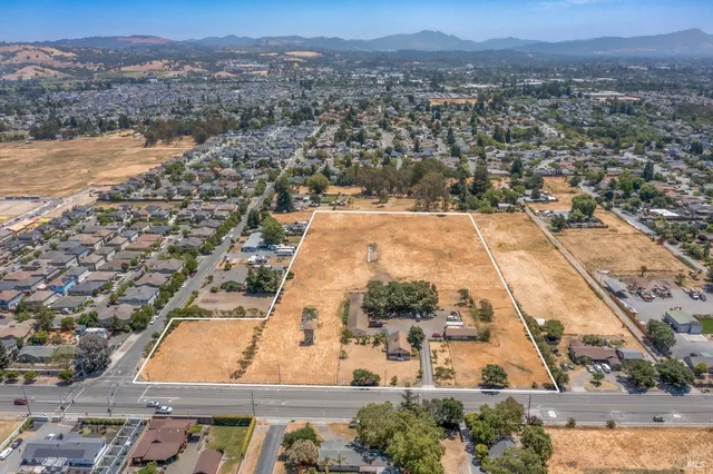 an aerial view of residential houses with outdoor space