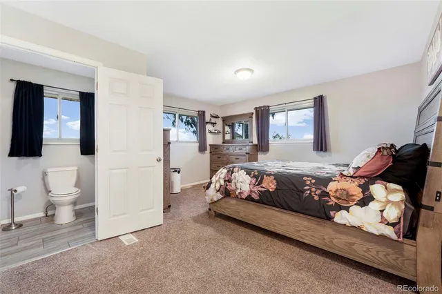 a view of a house with backyard and trees