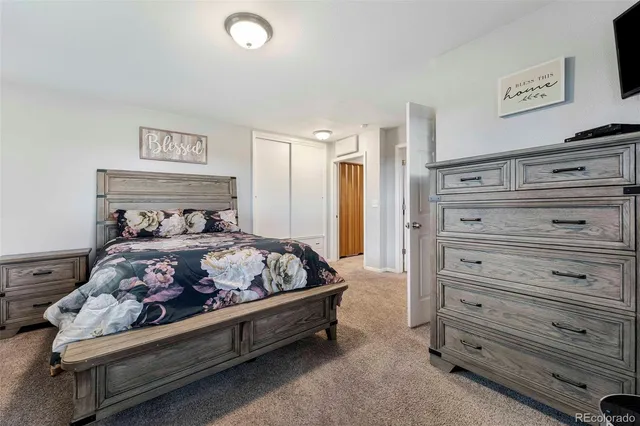 a large kitchen with stainless steel appliances kitchen island granite countertop a refrigerator and a sink