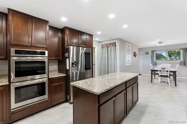 a front view of a house with a yard and trees
