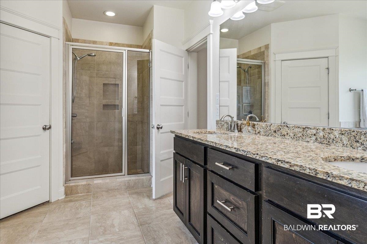7088 Rocky Rd Loop Gulf Shores, AL 36542 - Photo 32 of 39 Bathroom featuring a stall shower, double vanity, and recessed lighting