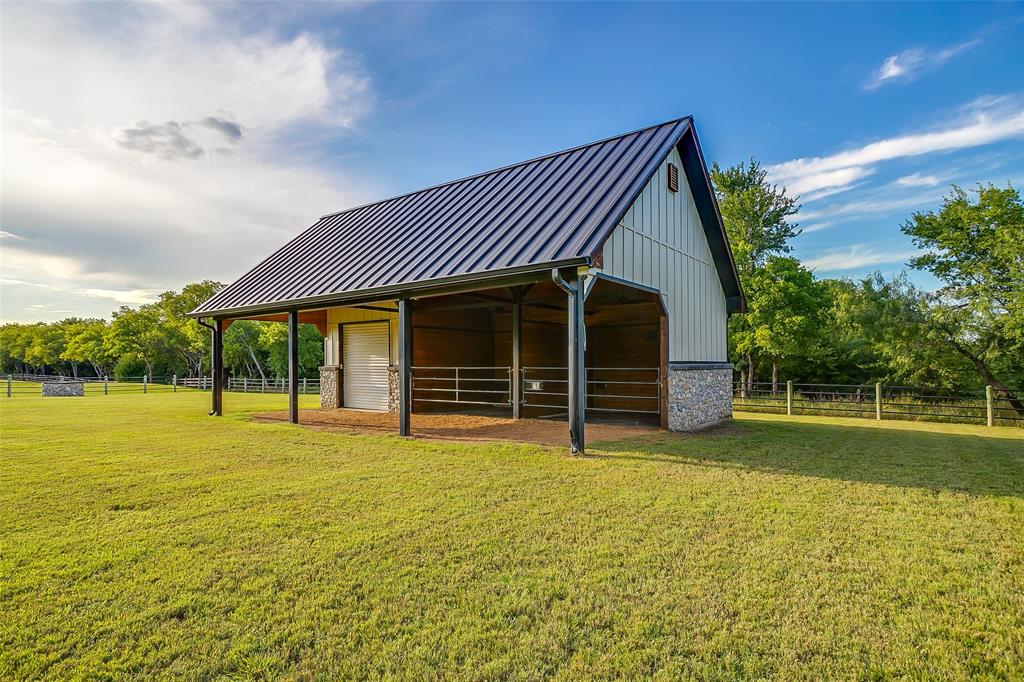 5000 T W King Road Southlake, TX 76092 - Photo 30 of 40 Exterior building provides additional covered space, extra stalls, and a dedicated storage room for flexible use.