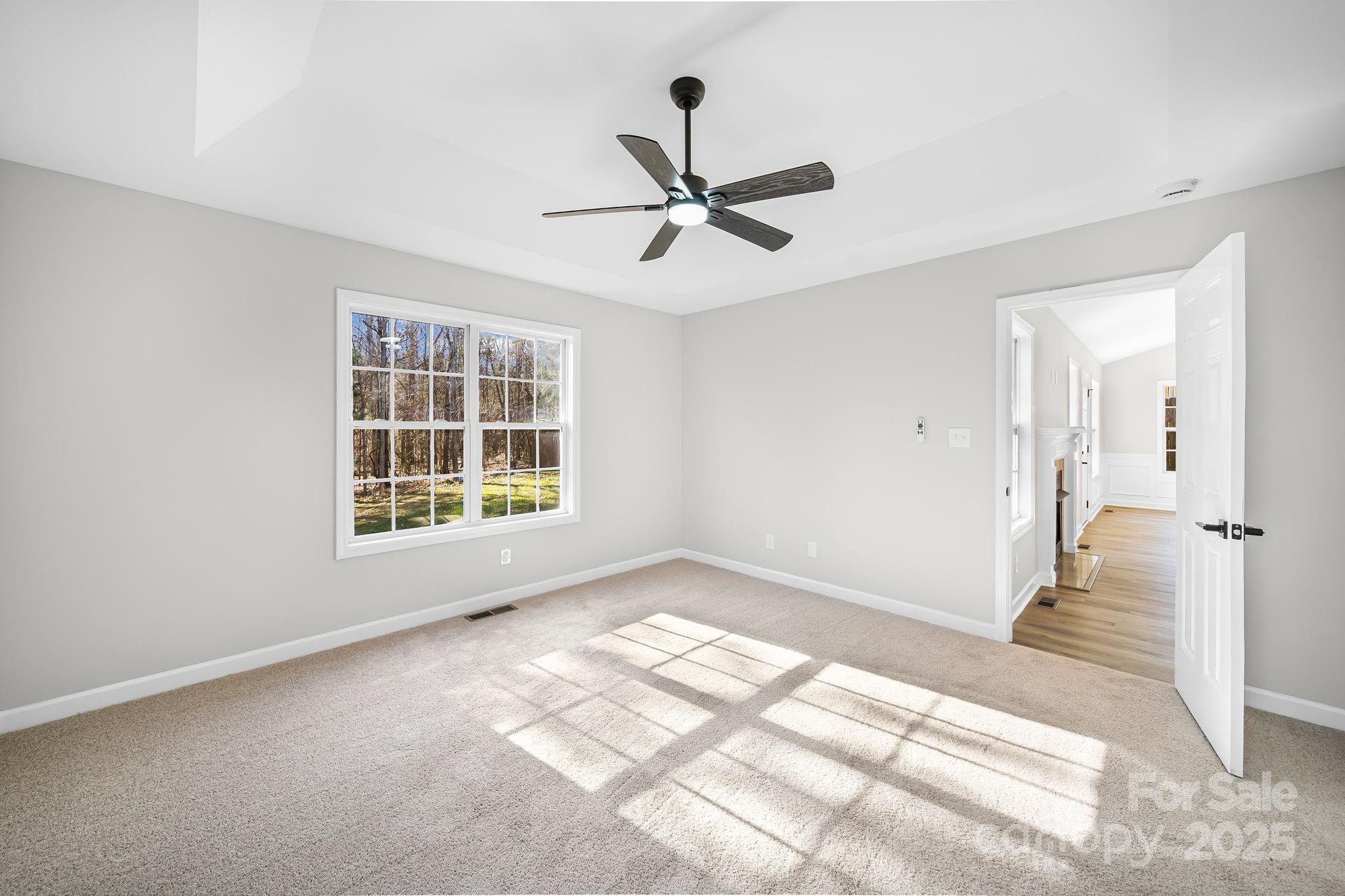 1562 Piney Church Road Concord, NC 28025 - Photo 19 of 40 a view of empty room with wooden floor and fan