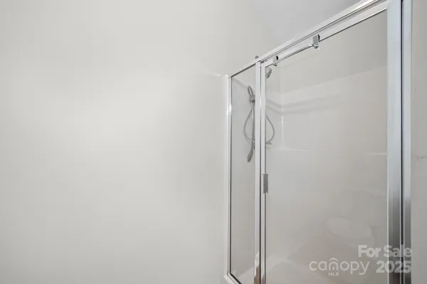 a bathroom with a glass shower door