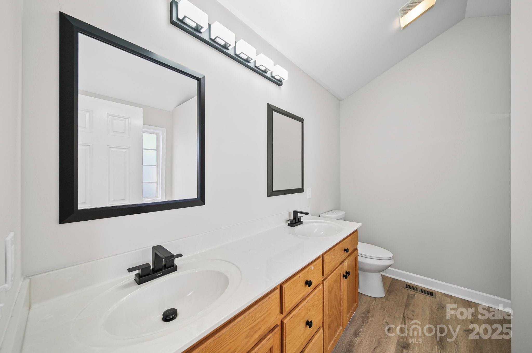 1562 Piney Church Road Concord, NC 28025 - Photo 27 of 40 a bathroom with a sink a toilet and mirror