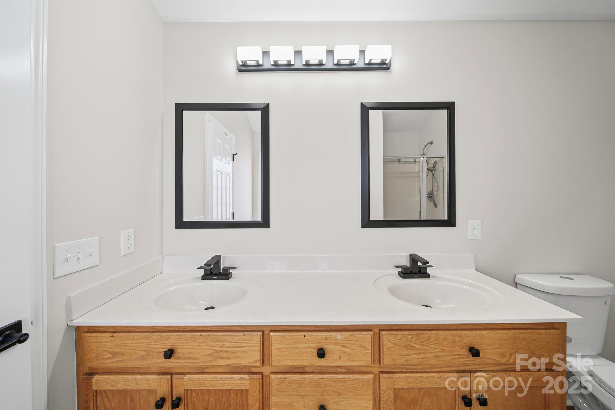 1562 Piney Church Road Concord, NC 28025 - Photo 28 of 40 a bathroom with a sink vanity and mirror