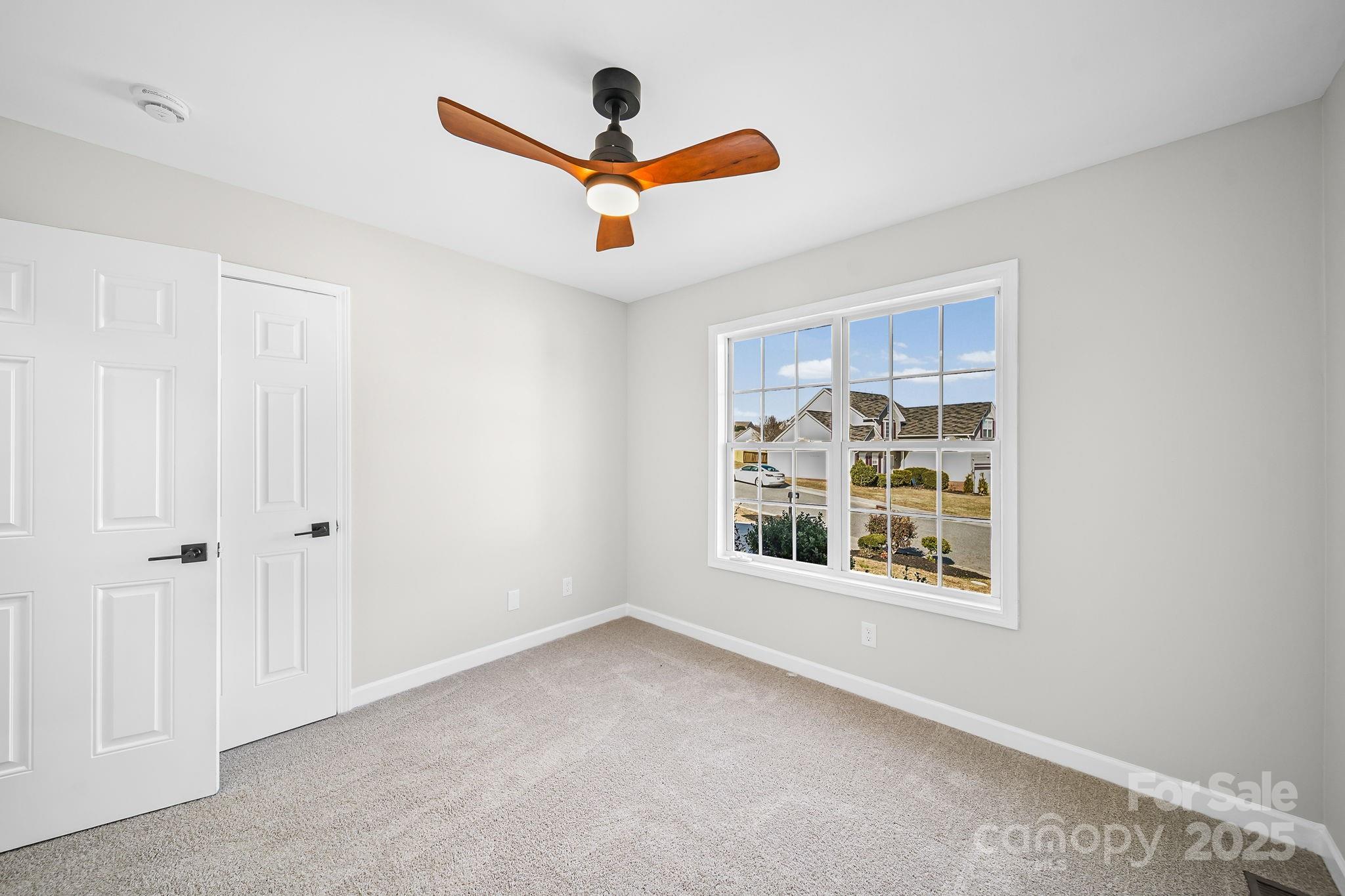 1562 Piney Church Road Concord, NC 28025 - Photo 31 of 40 an empty room with a ceiling fan and window