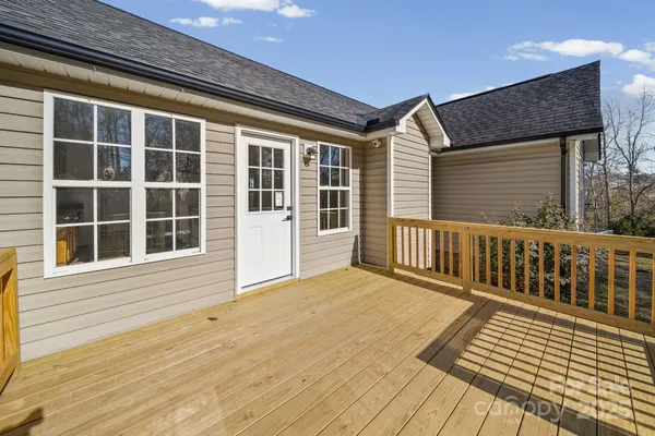 a view of balcony with wooden floor and fence