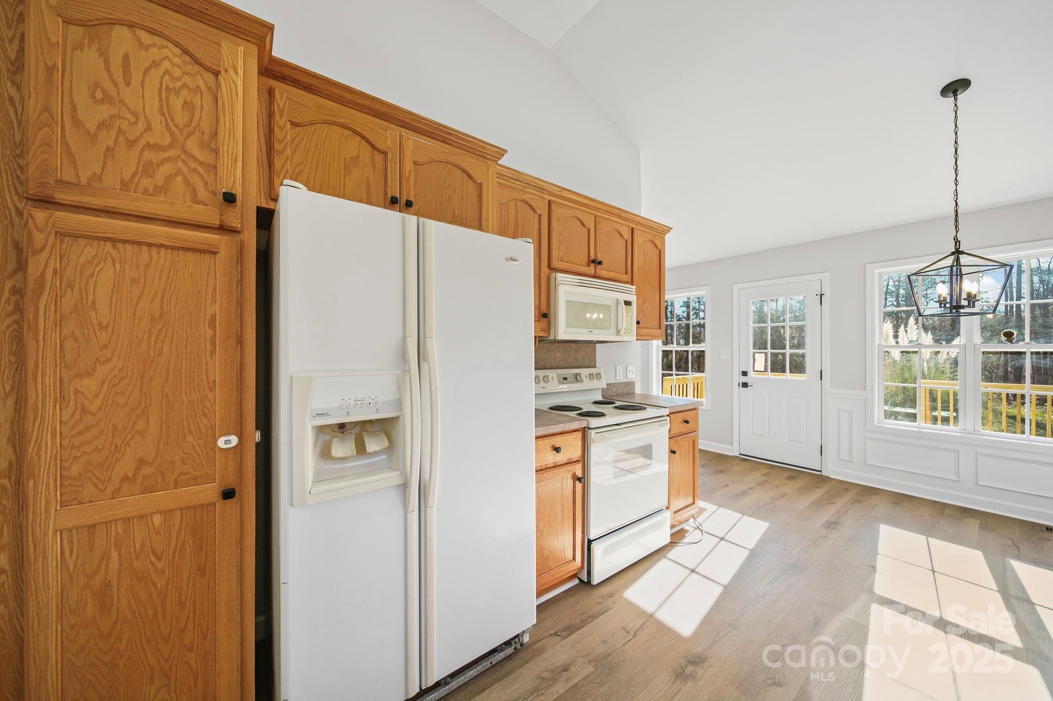 1562 Piney Church Road Concord, NC 28025 - Photo 6 of 40 a kitchen with stainless steel appliances a refrigerator and a stove top oven