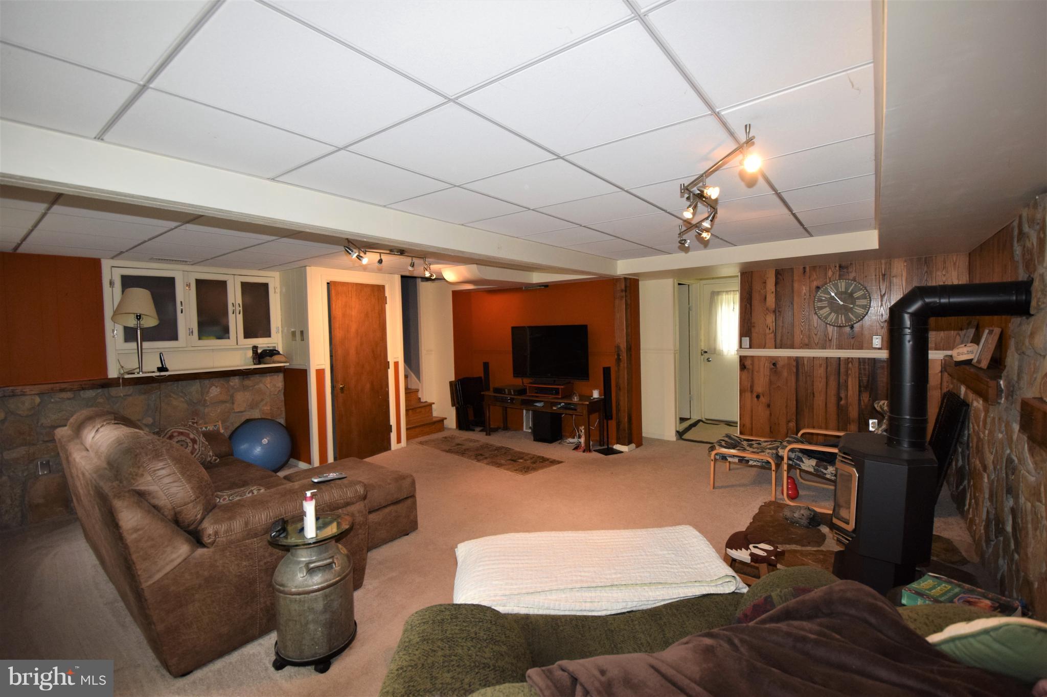 4836 Teen Barnes Road Frederick, MD 21703 - Photo 13 of 29 a living room with furniture a flat screen tv and a window