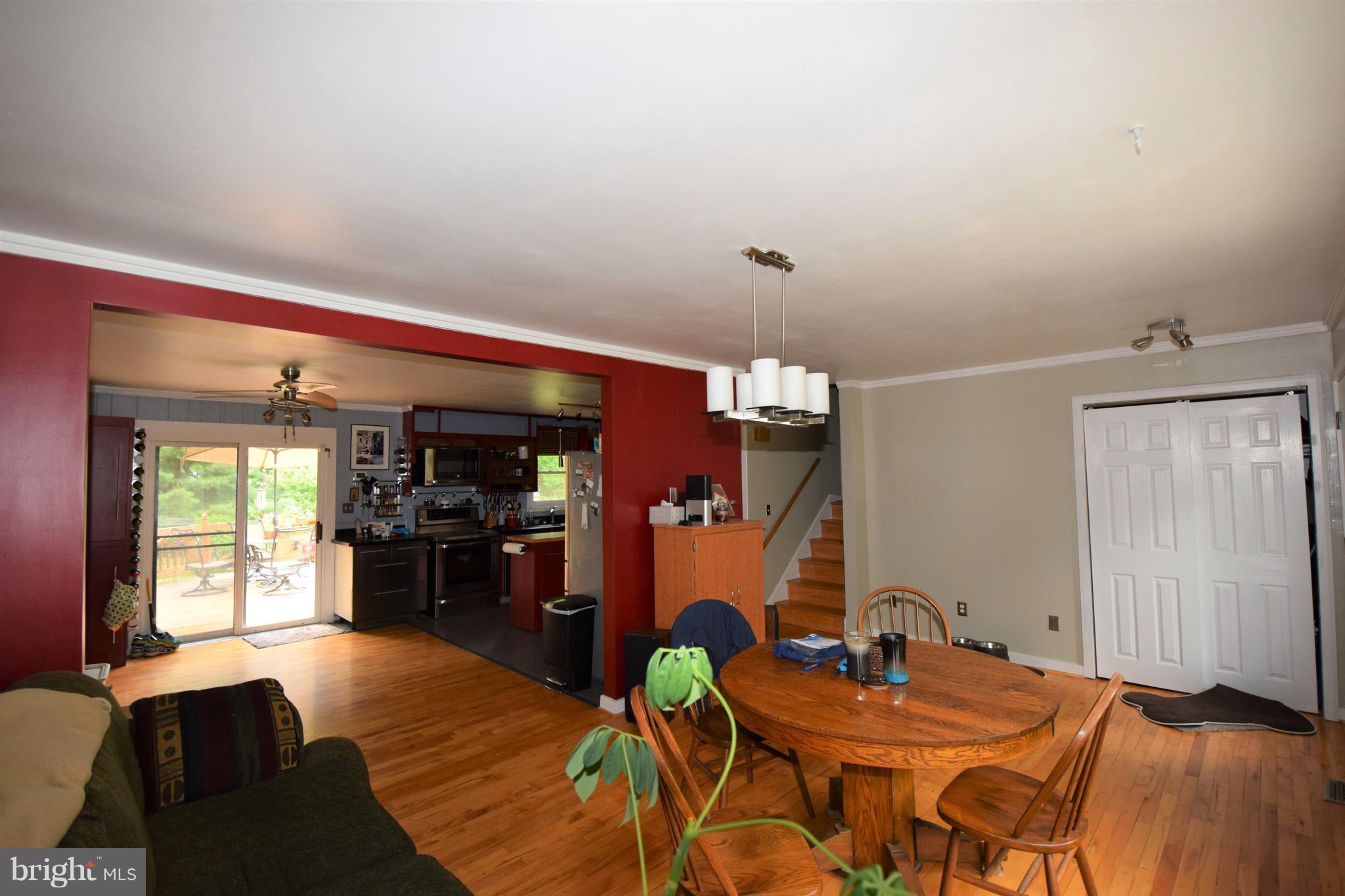4836 Teen Barnes Road Frederick, MD 21703 - Photo 3 of 29 a view of a dining room with furniture and wooden floor